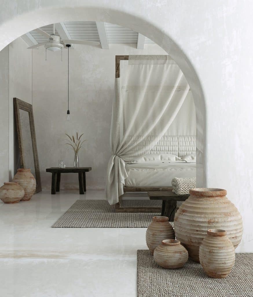 Chambre minimaliste aux tons neutres avec lit à baldaquin drapé et groupe de vases en terre cuite. Ambiance sereine soulignée par la lumière douce et les textures naturelles.